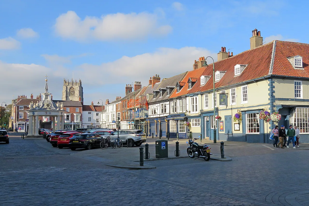 Beverley Saturday Market. The Market Cross, on the left, is the meeting point for three of the festival's free walks, and St Mary's Church behind it is the start for three more